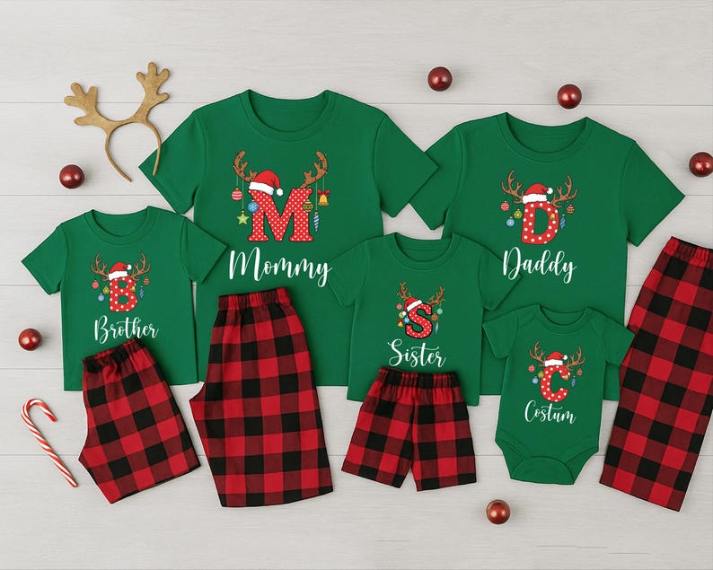 May include: A family Christmas pajama set in green with red and black plaid bottoms. The shirts have reindeer antlers and the letters "M", "D", "S", "C", and "B" with the words "Mommy", "Daddy", "Sister", "Costum", and "Brother".