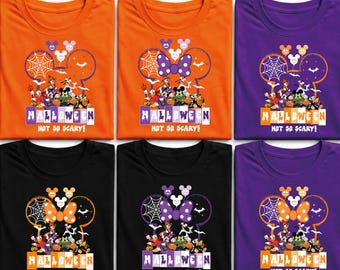 May include: A collection of six t-shirts in orange, purple, and black featuring a graphic of Disney characters in a Mickey-shaped outline with spiderwebs, bats, and pumpkins. The text reads HALLOWEEN NOT SO SCARY! in a stylised, dripping font.