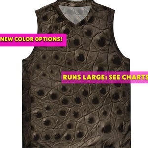 May include: A sleeveless V-neck shirt featuring a brown and black crocodile skin pattern. The image includes two pink rectangular text boxes with yellow text that read NEW COLOR OPTIONS! and RUNS LARGE: SEE CHARTS.