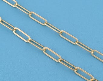 May include: A gold-toned chain necklace featuring elongated, rectangular paperclip-style links. The chain consists of two parallel strands of polished metal links that are connected in a repeating, uniform pattern across the entire length.