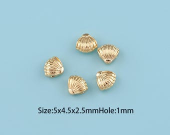 May include: Five gold-colored seashell beads on a light blue background. The beads have a ribbed texture and a small hole. The text on the image reads: Size: 5x4.5x2.5mm Hole: 1mm.