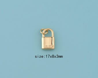 May include: A gold-colored padlock charm with the word "BELIEVE" engraved on the front. The charm measures 17x8x3mm and hangs from a small loop. The background is a solid light blue.