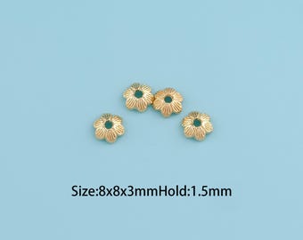 May include: Four gold-colored flower-shaped beads with a central hole, set against a light blue background. The beads are approximately 8mm in diameter and 3mm thick, with a 1.5mm hole.