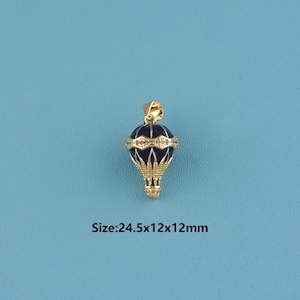 May include: A gold-colored hot air balloon pendant with a dark blue body and gold accents. The pendant has a small loop at the top for a chain. The dimensions are 24.5x12x12mm.