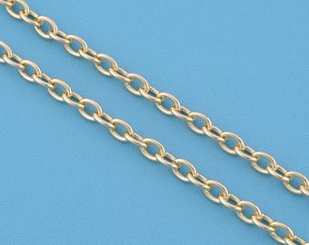 May include: A gold-toned metal chain necklace featuring a series of uniform, oval-shaped interlocking links. The chain is displayed in two parallel strands, showcasing the polished, reflective surface and the consistent construction of the links.