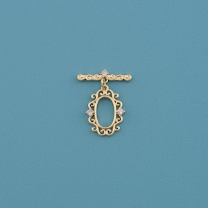 May include: A gold-colored brooch with an oval, openwork design and three small, clear gemstones. The brooch has a decorative bar at the top and is set against a teal background.