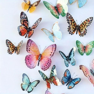 May include: A collection of colorful butterfly decorations in various sizes and patterns. The butterflies feature a range of colors, including orange, pink, blue, green, and yellow, with detailed wing designs. The butterflies are arranged on a white background.