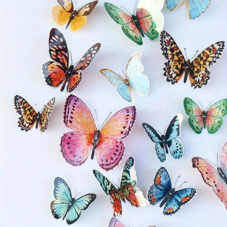 May include: A collection of colorful butterfly decorations in various sizes and patterns. The butterflies feature a range of colors, including orange, pink, blue, green, and yellow, with detailed wing designs. The butterflies are arranged on a white background.