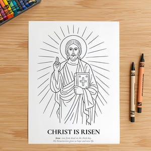 May include: Black and white line drawing of Jesus holding a book with a cross, encircled by a halo. The text "CHRIST IS RISEN" is below the image, with a quote. Crayons and colored pencils are on a wooden surface.
