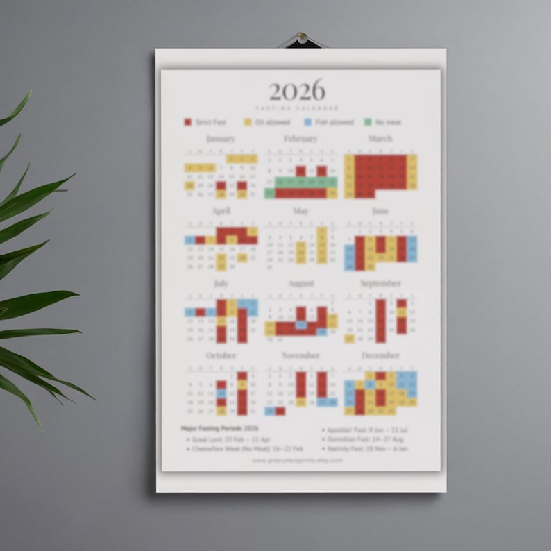May include: A 2026 fasting calendar, displayed on a white poster. The calendar features color-coded blocks indicating fasting periods, with text at the top and bottom. The poster is hanging on a wall.