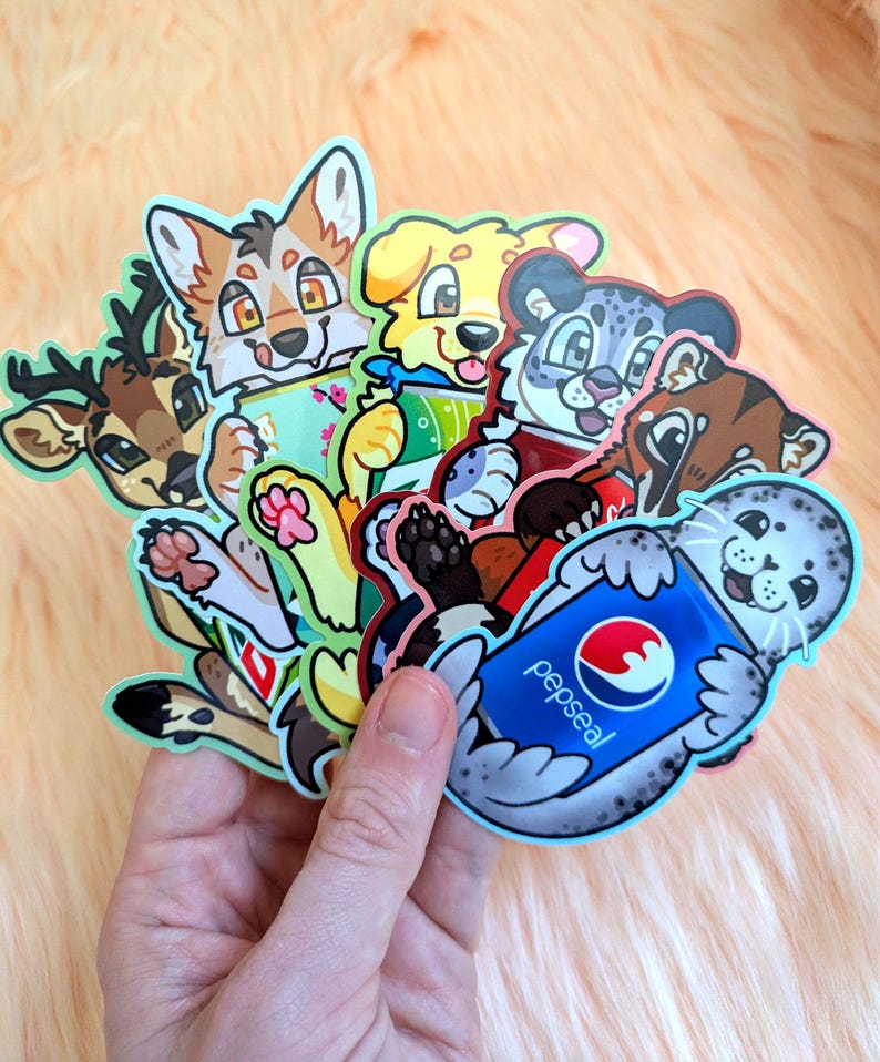 May include: A collection of die-cut vinyl stickers featuring cartoon animals, including a deer, a fox, a yellow dog, a snow leopard, and a spotted seal holding a blue soda can with the text pepseal printed in white and a red and blue circular logo.
