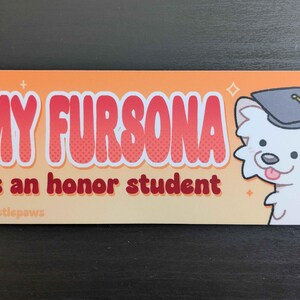 Puede incluir: Una pegatina rectangular con fondo naranja y el texto "MY FURSONA is an honor student" en letras rojas y blancas. Un perro de dibujos animados con birrete est&aacute; en el lado derecho. La pegatina tiene un dise&ntilde;o lindo y juguet&oacute;n.