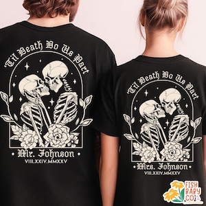 May include: Black t-shirts with a skeleton couple design. The design includes the text "Til Death Do Us Part" and the names "Mr. Johnson" and "Mrs. Johnson" with a wedding date. The graphic features skeletons kissing, surrounded by floral elements.