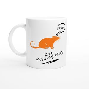 May include: White ceramic mug featuring an orange rat illustration and the text "Rat thawing mug." A thought bubble above the rat says "Fuck!" The mug has a curved handle.