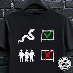 May include: Black t-shirt featuring a white snake illustration, a green tick in a box, a red cross in a box, and stick figures. The shirt also has the text "Cold Blooded Club" in a circular design.
