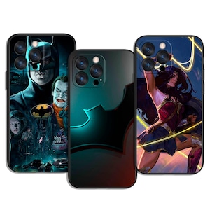 May include: Three phone cases featuring DC Comics characters. One case displays Batman and the Joker, another has a black bat symbol, and the third showcases Wonder Woman. The cases have black borders and colorful graphics.