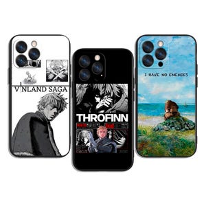 May include: Three phone cases featuring artwork from the anime series Vinland Saga. One case has the text "VINLAND SAGA" and a character illustration. Another case displays "THORFINN" with character images. The third case has the text "I HAVE NO ENEMIES" with a landscape.