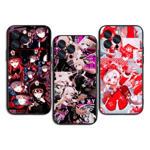 May include: Three phone cases with colorful anime-style character designs. The cases feature red, black, and white backgrounds with various character illustrations. The cases are designed to fit a smartphone.