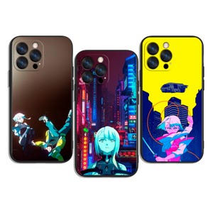 May include: Three phone cases with anime-style graphics. One case has a brown gradient with two figures. The second case has a cityscape with neon lights. The third case is yellow with a futuristic vehicle and a figure holding a sword.