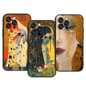 May include: Three phone cases with artistic designs. One features a fox and rabbit, another depicts a couple embracing, and the third showcases a woman's face. The cases have black borders and camera cutouts.