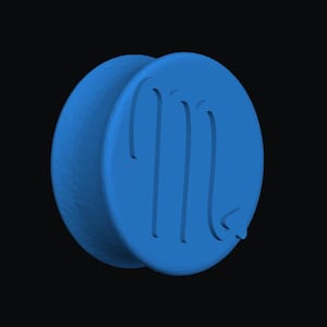 May include: A blue, circular pendant with a raised Scorpio symbol. The pendant is a solid, three-dimensional design, set against a black background. The Scorpio symbol is a stylized 'M' with a tail.