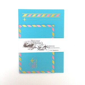 May include: A stationery kit with a blue and pink airmail envelope design. The kit includes envelopes and letterheads. The text on the packaging reads "Not your Granny's Air Mail Stationery Kit".