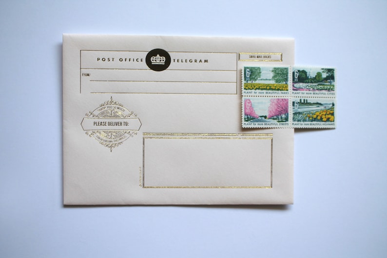 May include: A cream-colored envelope with gold trim and the text "POST OFFICE TELEGRAM" printed on the front. The envelope has a decorative stamp with the text "PLEASE DELIVER TO:" and a crown logo. Four postage stamps are attached to the upper right corner of the envelope. The stamps feature images of trees, flowers, and a bridge. The text on the stamps reads "PLANT for more BEAUTIFUL PARKS".