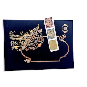 May include: A navy blue card with gold foil accents, featuring a detailed bird illustration and the text "Kindly Deliver To". Three "Thank You" stamps in burgundy, blue, and gold are attached.