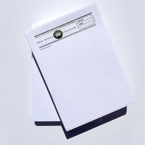 May include: A stack of blank white paper telegram forms with a black and silver printed header that reads "Post Office Telegram". The header also includes a crown graphic.