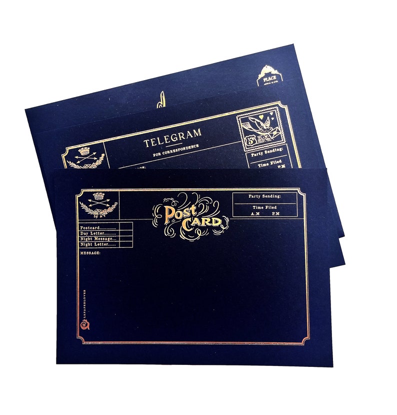 May include: A stack of navy blue postcards and telegrams with gold foil lettering and accents. The postcards feature the word "Post Card" in an ornate font, while the telegrams read "Telegram for Correspondence". The design includes decorative borders and space for writing.
