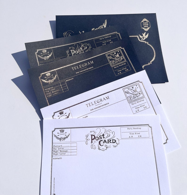 May include: A stack of vintage-style postcards and telegrams. The postcards are white with gold lettering that reads "Post Card." The telegrams are black and white with gold lettering that reads "Telegram."