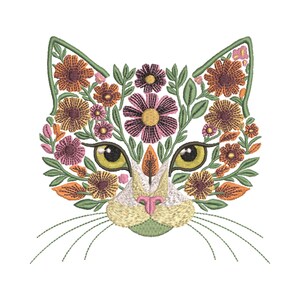 May include: Embroidered cat face design featuring a floral pattern. The cat's face is outlined in green, with yellow eyes and a pink nose. The floral pattern includes orange, pink, and purple flowers with green leaves. The design is on a white background.