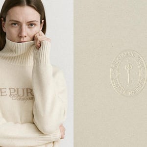 May include: A woman wearing a cream-colored turtleneck sweater with the word "EPUR" embroidered on the front. The sweater has ribbed cuffs and a high neckline. The right side of the image shows a cream-colored oval logo with the text "THE CLASSIC STORE MODERN TIMELESS".