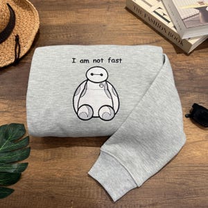 I Am Not Fast Embroidered Sweater, Cute Cartoon Shirt Gift for Friends, Him or Her, Baymax-Inspired Embroidery for Couples & Birthdays EH439