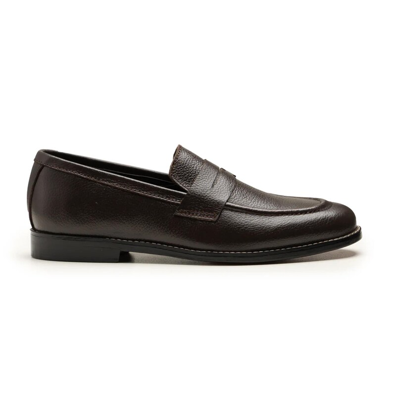 May include: A single brown leather loafer shoe with a textured surface. The shoe has a rounded toe, a penny strap, and a black sole with white stitching. The shoe is designed for casual or formal wear.