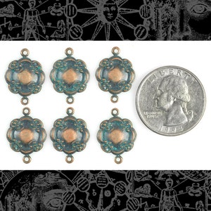 May include: Six antique copper and green metal connector charms with a scalloped edge and two loops. The charms are about the size of a UK 20 pence coin.
