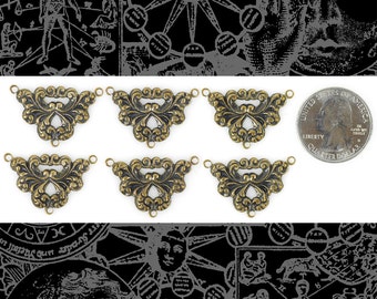 May include: Six antique gold-toned metal decorative embellishments with a scalloped design. Each embellishment has three holes for attaching to a project. A US quarter is shown for scale.