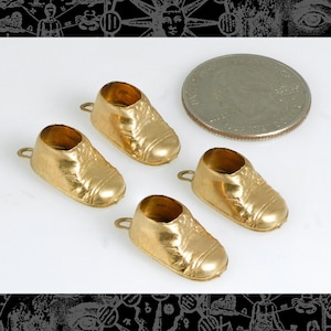 May include: Four gold-colored baby shoe charms. The charms are about the size of a US quarter.