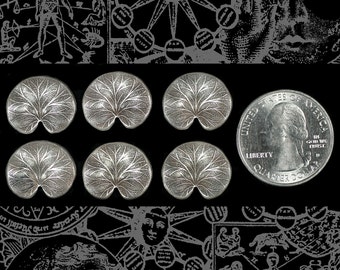 May include: Six silver-toned metal charms in the shape of water lily pads. The charms are arranged in two rows of three. The charms are approximately 1 inch in diameter. A US quarter is shown for scale.