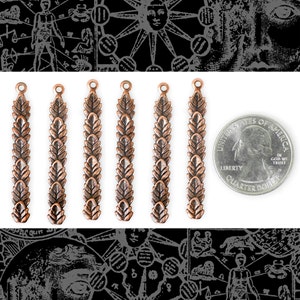 May include: Seven antique copper-colored metal charms, each featuring a design of a row of leaves. The charms are approximately the size of a US quarter.