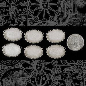 May include: Six silver oval-shaped metal trays with a decorative border. The trays are arranged in two rows of three. A US quarter is included for scale.