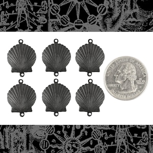 May include: Six black metal scallop shell charms with two holes each. The charms are approximately the size of a US quarter.