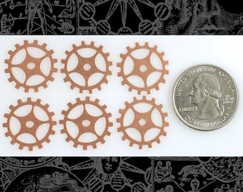 May include: Six copper gears of varying sizes, with a US quarter for scale. The gears have a starburst design in the center and are arranged in two rows of three.