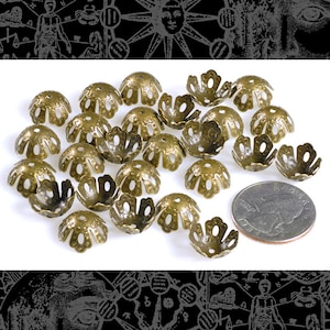May include: A group of 20 antique gold-toned metal bead caps with a flower design. The caps are approximately the size of a US quarter.