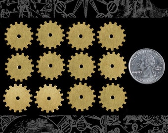 May include: A collection of twelve small, brass-colored gear wheels with a central hole, arranged on a black background. A U.S. quarter coin is included for size comparison. The gears have a steampunk aesthetic.
