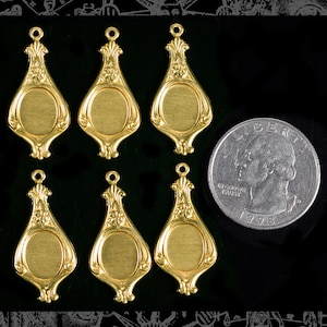 May include: Six gold-tone metal pendant charms with a teardrop shape and a round center. The charms have a decorative design around the edges. The charms are approximately the size of a US quarter.