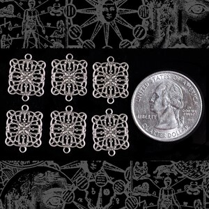 May include: Six silver filigree square charms with a decorative floral design. The charms have a loop at the top for attaching to jewelry or other crafts.