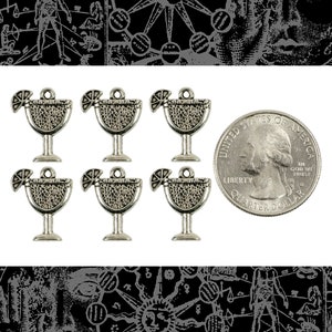 May include: Six silver-toned cocktail charms with a lemon wedge detail. Each charm is approximately the size of a U.S. quarter. The charms have a textured appearance and a small loop at the top for attaching to jewelry or other crafts.