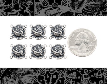 May include: Six silver-toned rose-shaped connector charms with four loops each. The charms are about the size of a US quarter.