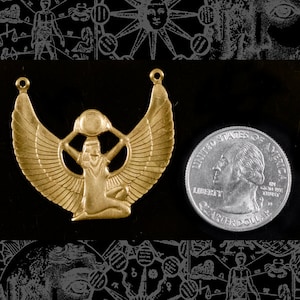 May include: Gold-toned metal pendant featuring a winged goddess figure holding a sphere aloft. The pendant is approximately the size of a US quarter.